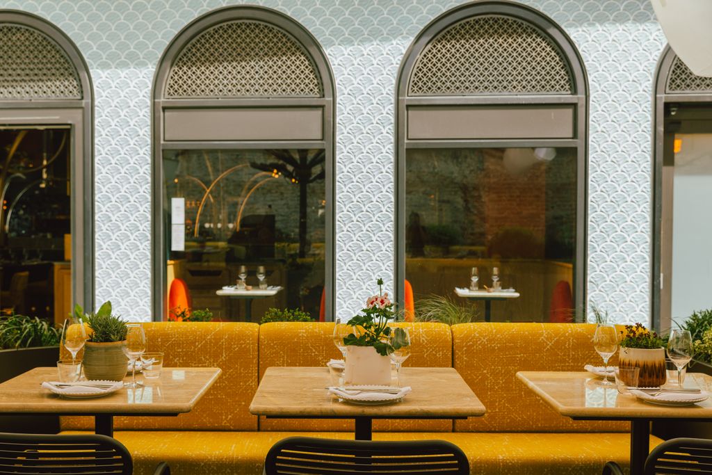 Image may contain Architecture Building Dining Room Dining Table Furniture Indoors Room Table Restaurant and Cup