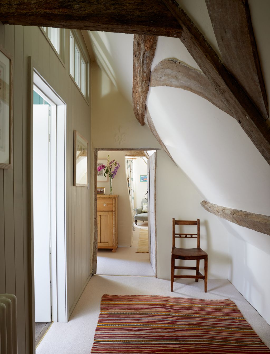 Image may contain Chair Furniture Architecture Building House Housing Indoors Loft Room Home Decor and Rug