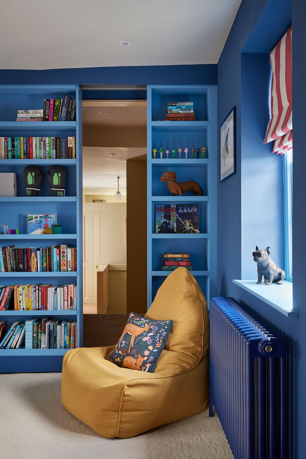 Image may contain Furniture Art Painting Couch Lamp Bookcase Person Animal Canine Dog Mammal and Pet