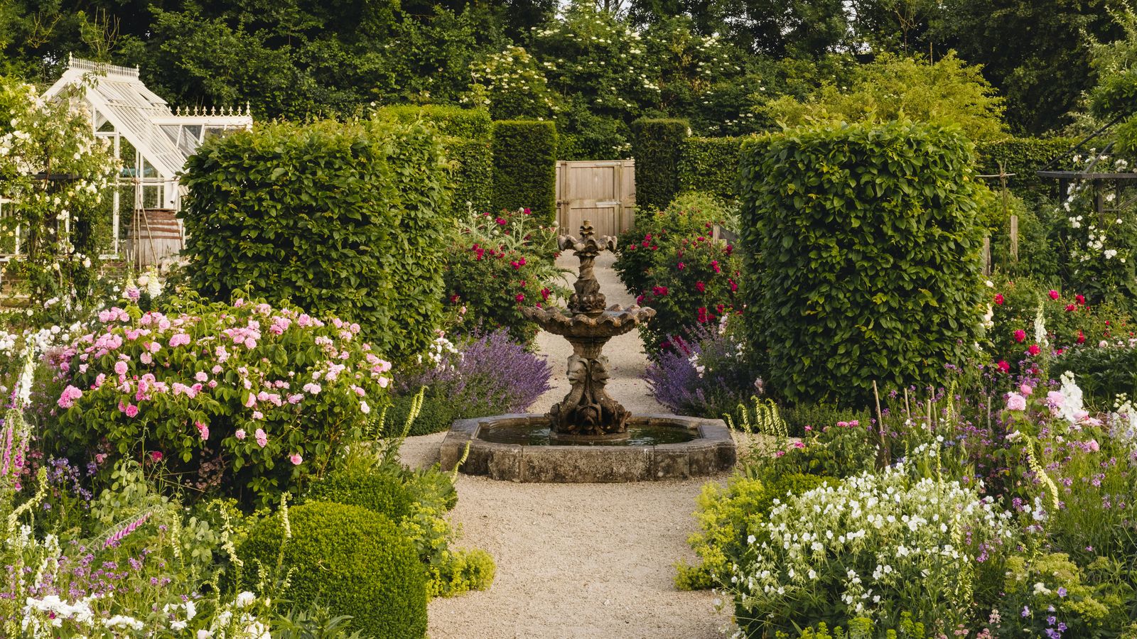 Image may contain: Garden, Nature, Outdoors, Grass, Park, Plant, Vegetation, Arbour, Tree, Fence, Hedge, and Potted Plant