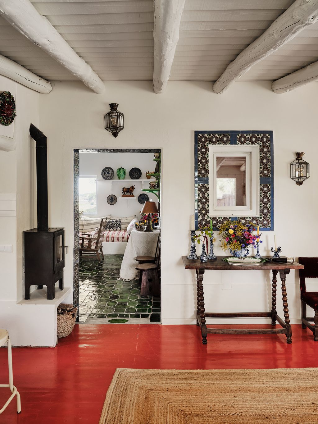 Image may contain Indoors Interior Design Lamp Home Decor Rug Chair Furniture Desk Table Floor and Plate