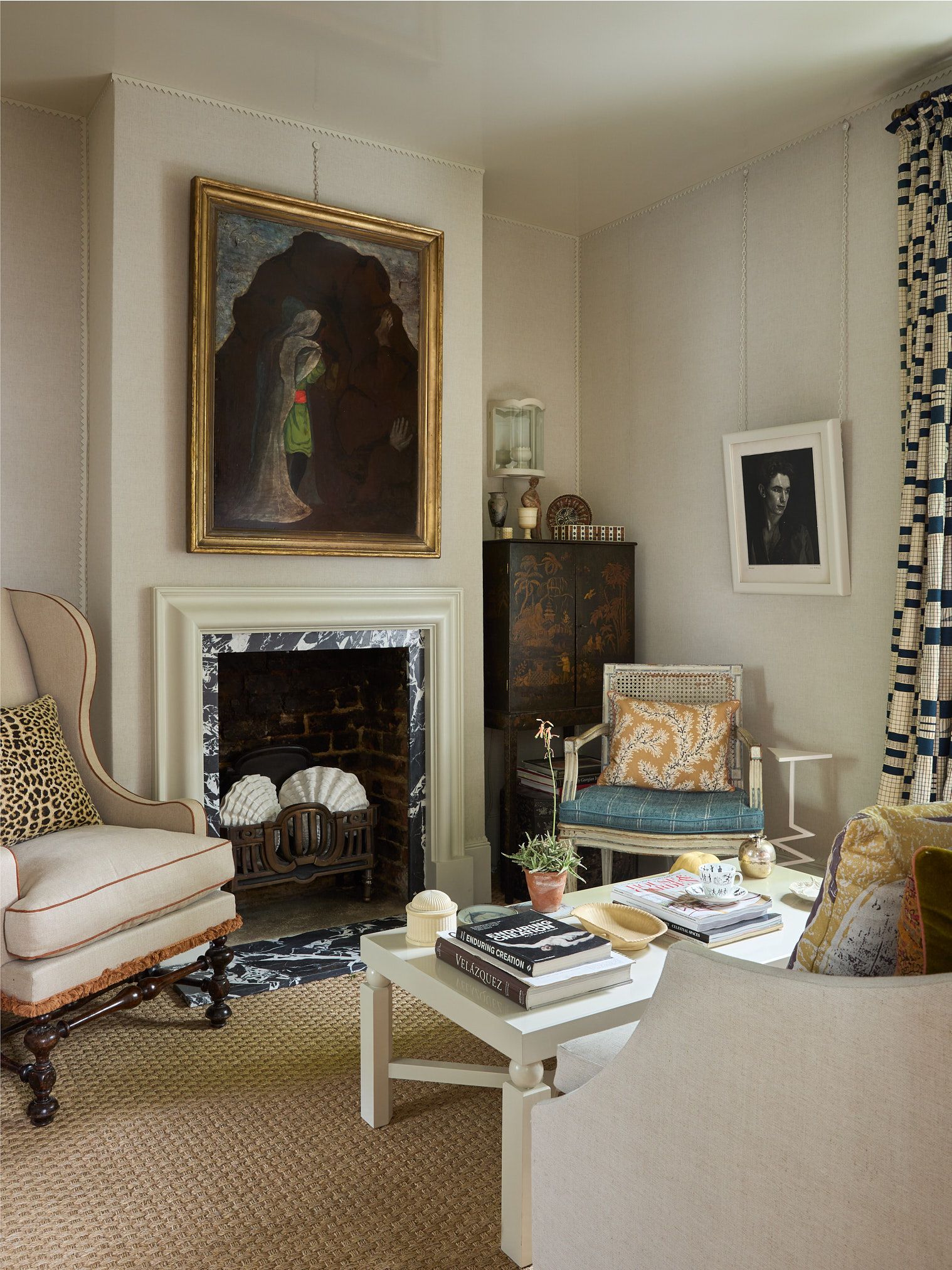 Image may contain Home Decor Chair Furniture Architecture Building Indoors Living Room Room Art Painting and Book