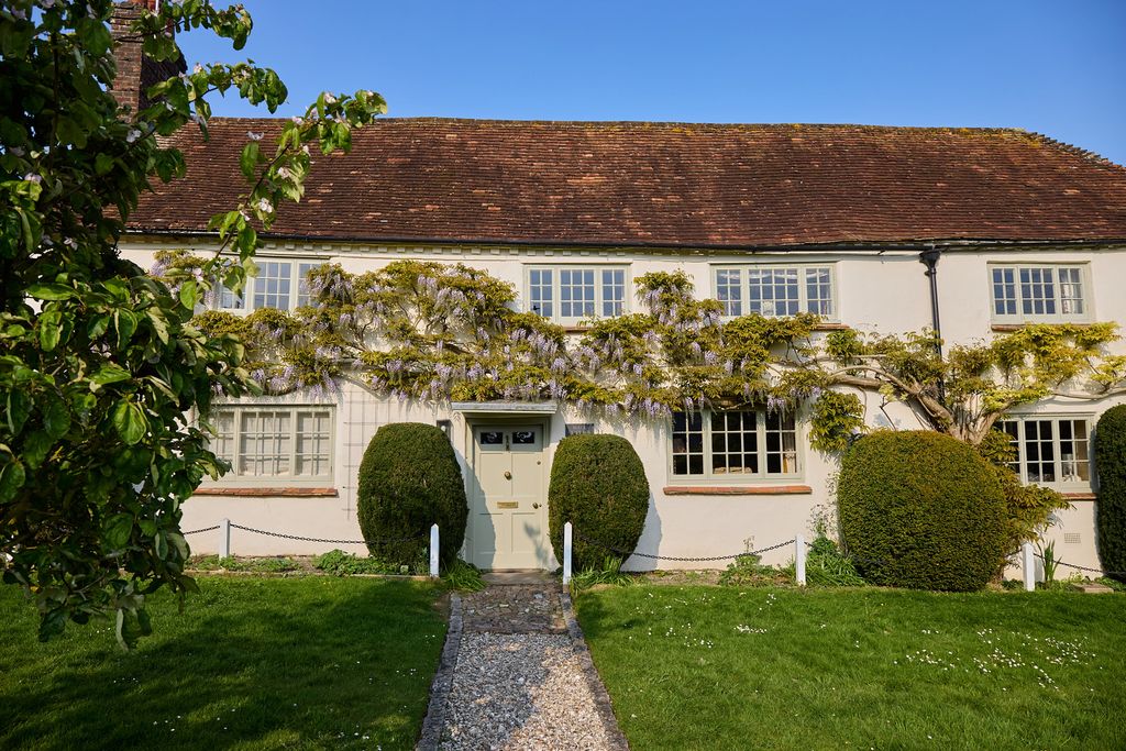 Image may contain Architecture Building Cottage House Housing Grass Plant Manor and Outdoors