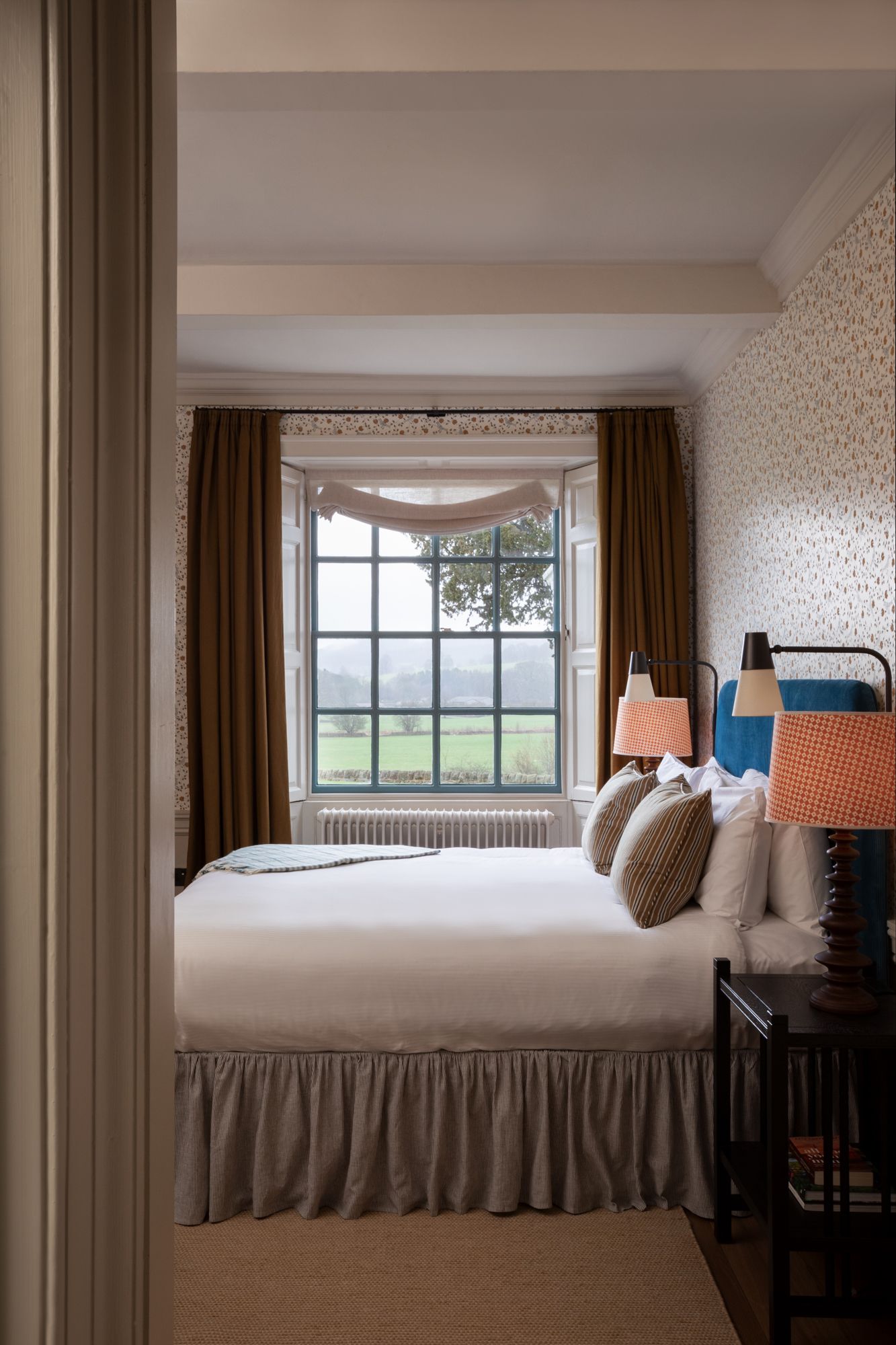 Image may contain Lamp Bed Furniture Indoors Interior Design Window Table Lamp Bay Window Bedroom and Room