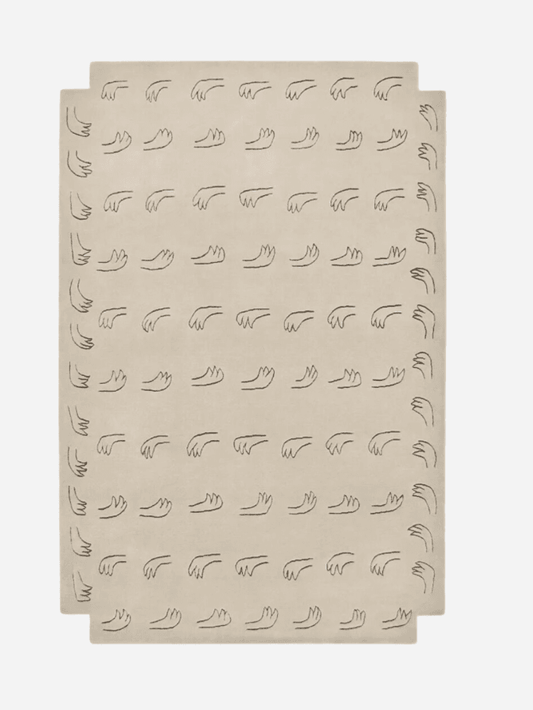 prints of outline of Hands in monogram pattern over a beige Rug, Nordic Knots