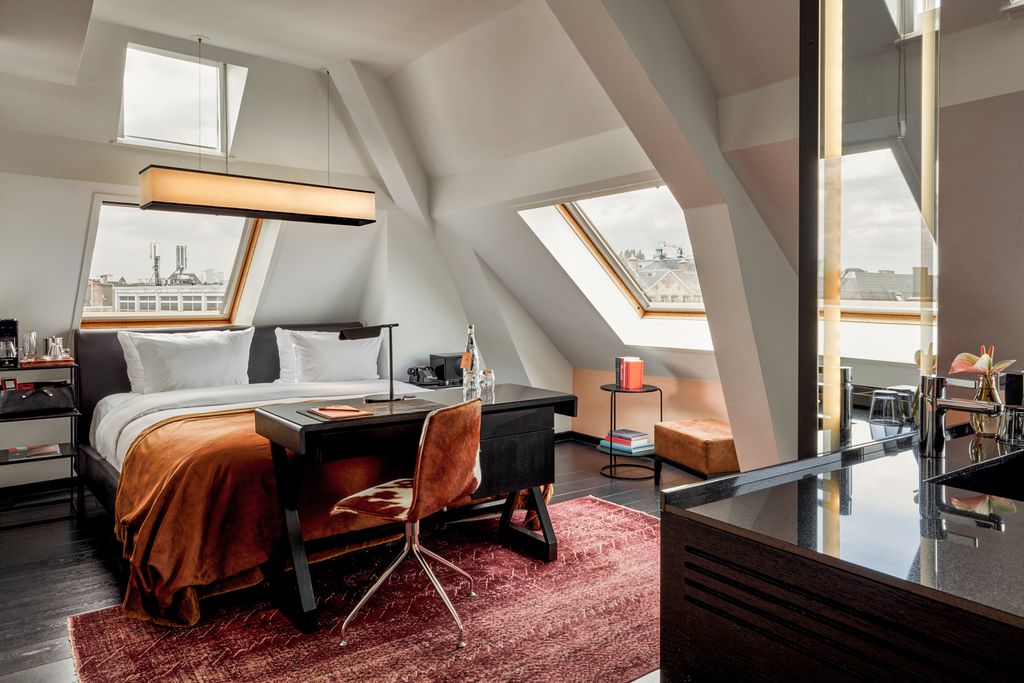 Image may contain Architecture Building House Housing Indoors Loft Room Home Decor Rug Chair Furniture and Bed