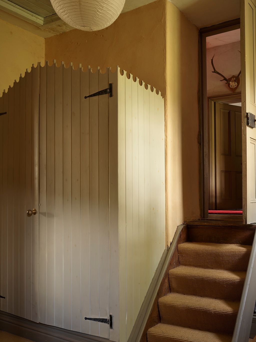 Image may contain Indoors Interior Design Architecture Building House Housing Staircase Wood Panels Wood and Foyer