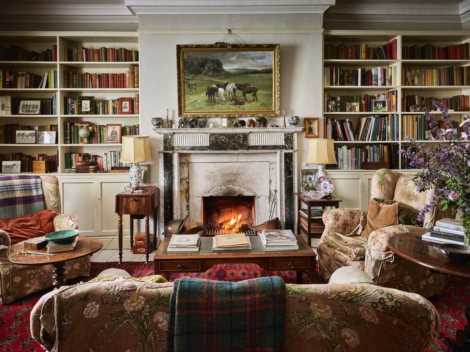 Image may contain Lamp Home Decor Fireplace Indoors Art Painting Book Publication Couch Furniture Desk and Table