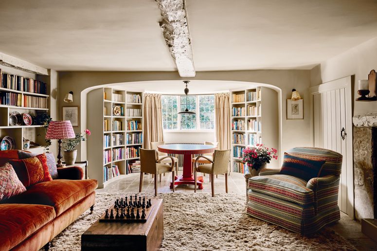 Image may contain: Home Decor, Lamp, Chair, Furniture, Couch, Desk, Table, Art, Painting, Rug, Candle, and Architecture