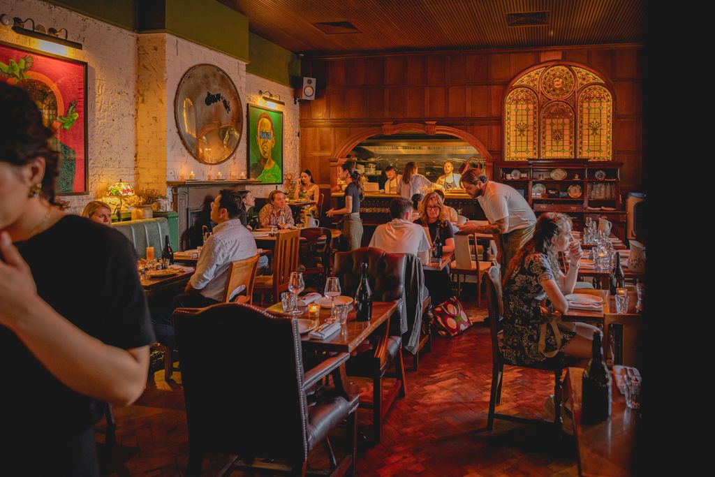 Image may contain Urban Architecture Building Dining Room Dining Table Furniture Indoors Room Table and Adult