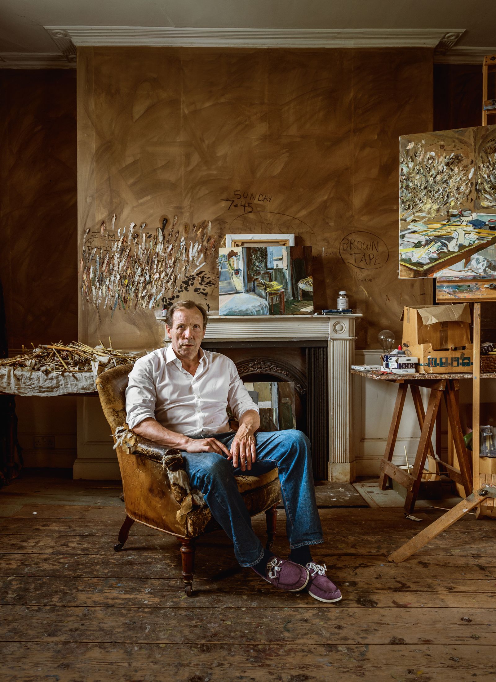 Image may contain Person Sitting Chair Furniture Wood Adult Clothing Footwear Shoe Desk Table and Box