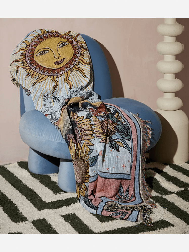 Image may contain: Home Decor, Furniture, Rug, Adult, Person, Chair, and Armchair