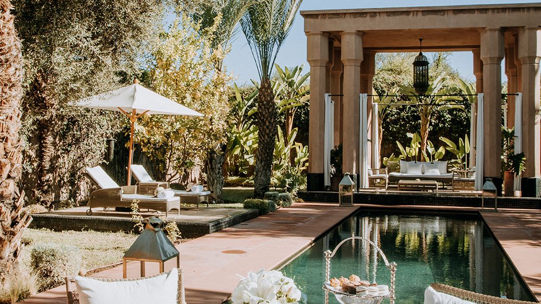 Image may contain: Dining Table, Furniture, Table, Blade, Knife, Weapon, Cup, Lamp, Chair, Plate, Plant, and Architecture