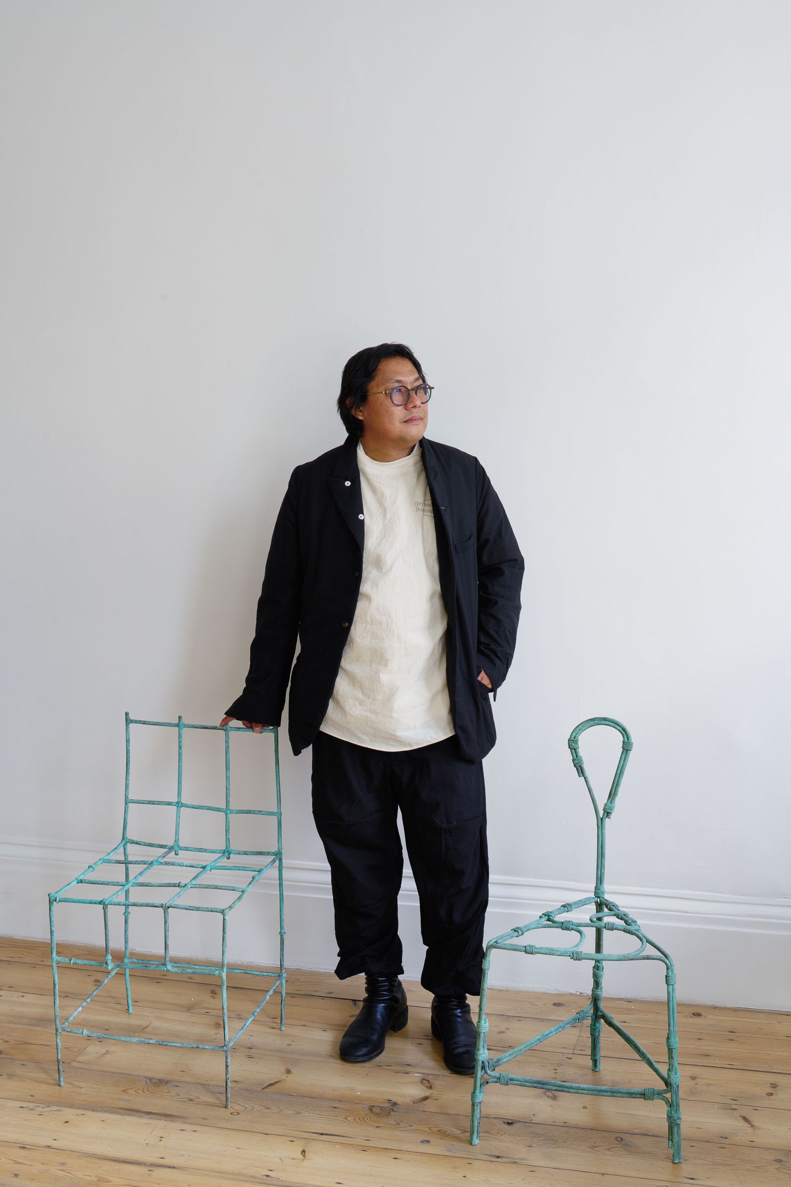 Image may contain Blazer Clothing Coat Jacket Person Standing Chair Furniture Adult Footwear Shoe and Accessories