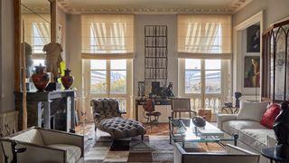 Image may contain Home Decor Book Publication Chair Furniture Couch Desk Table Person Architecture and Building