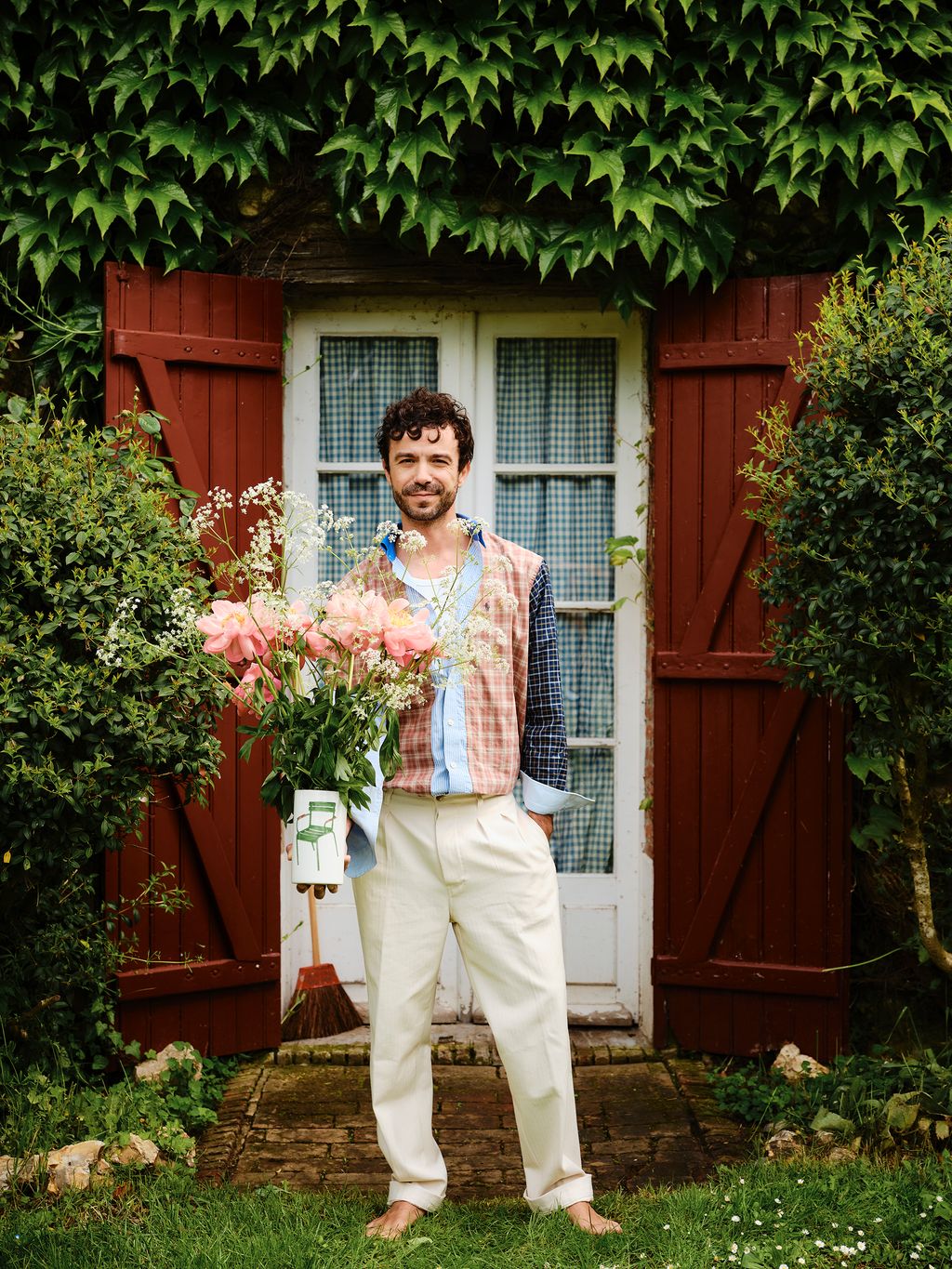 Image may contain Plant Potted Plant Face Head Person Photography Portrait Clothing Pants Jar Planter and Pottery