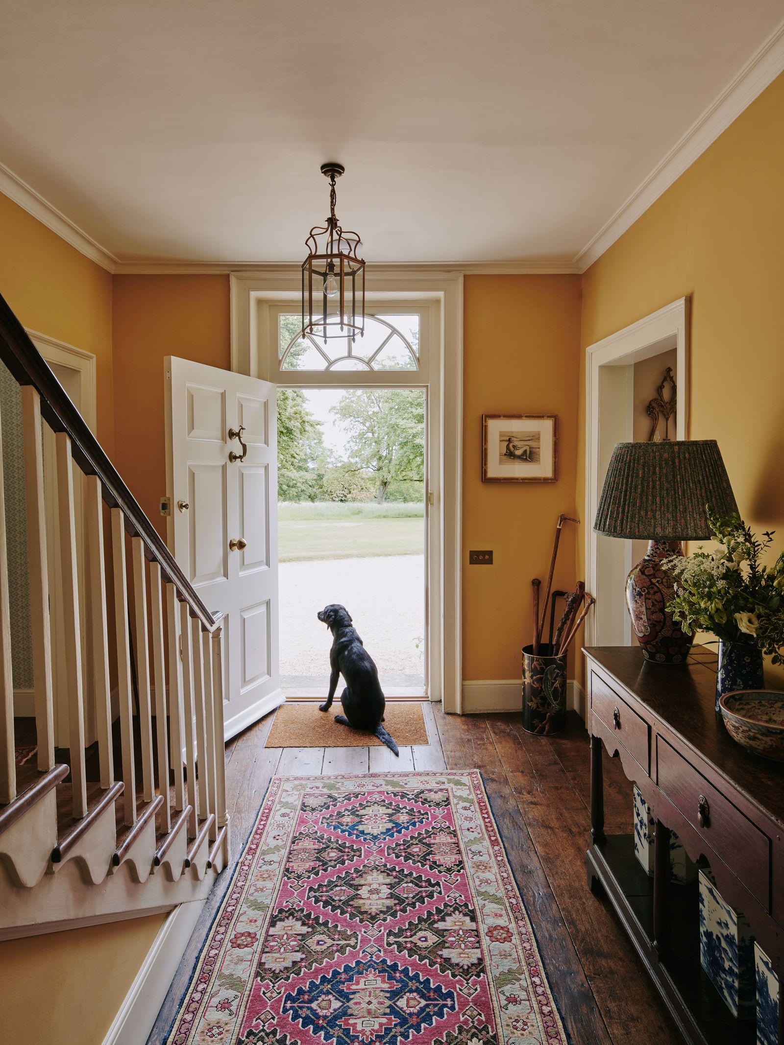 Image may contain Lamp Art Painting Home Decor Rug Indoors Architecture Building Foyer Animal Canine and Dog