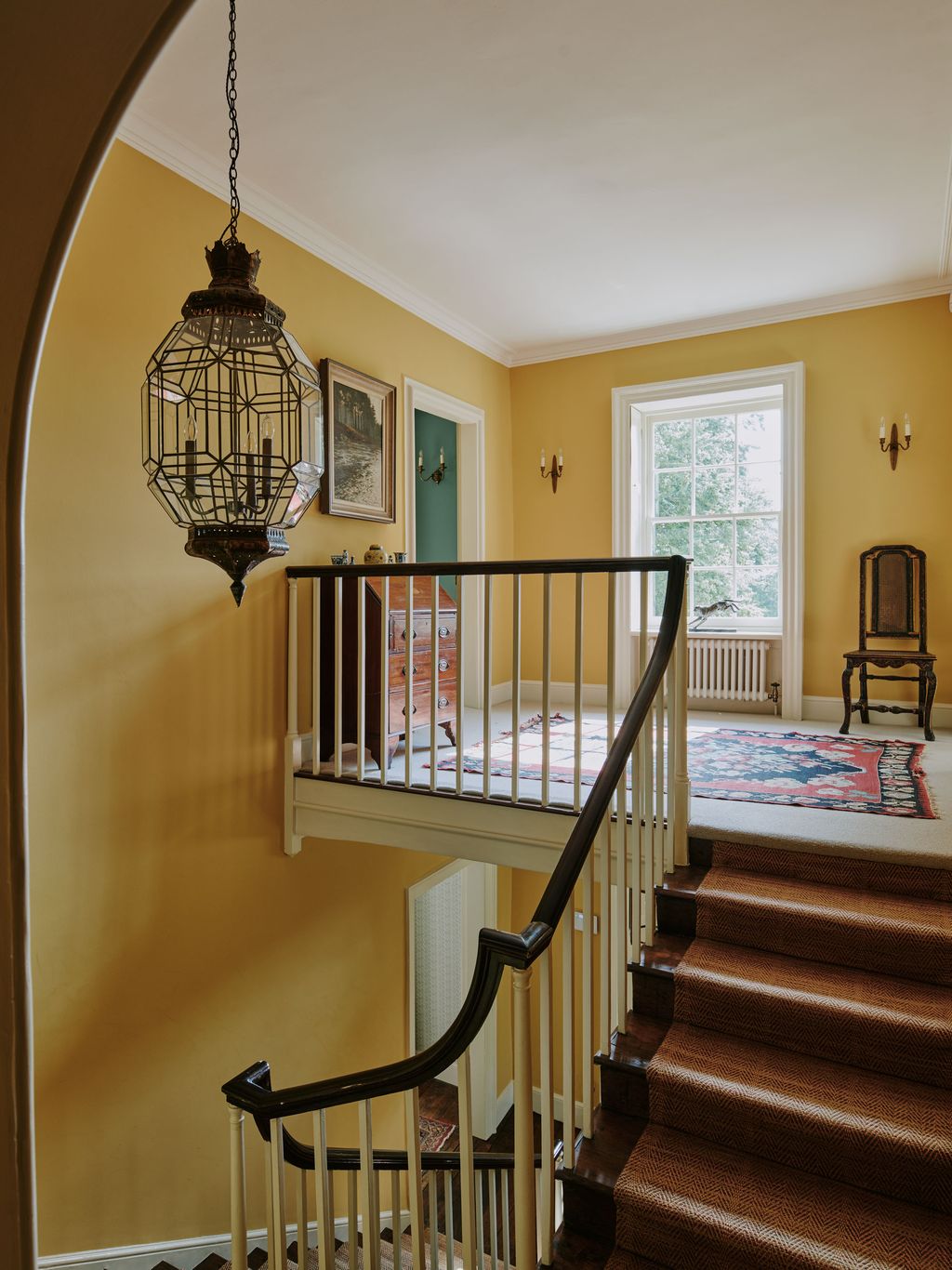 Image may contain Chair Furniture Architecture Building House Housing Staircase Lamp Art Painting and Foyer