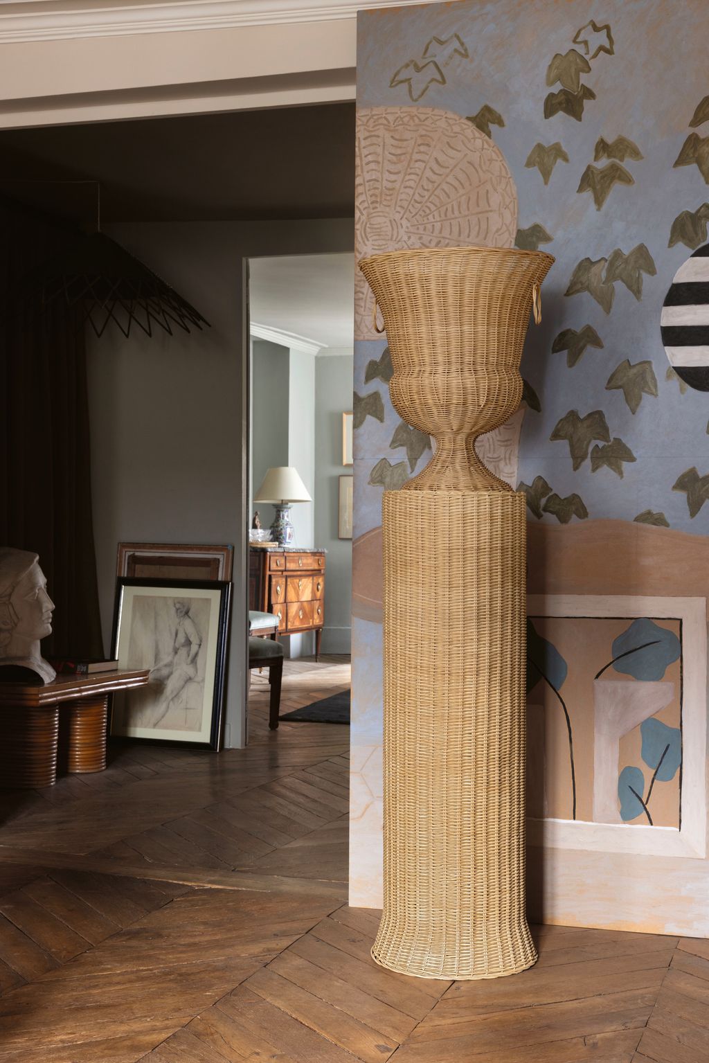 Image may contain Floor Flooring Indoors Interior Design Lamp Art Painting Person Wood Home Decor Rug and Chair