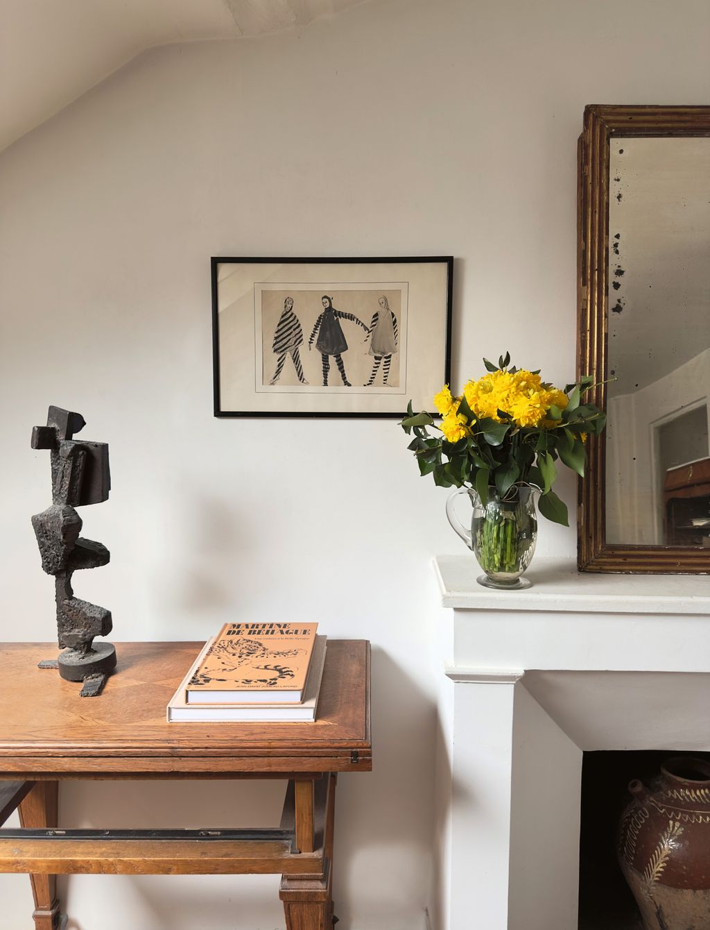 Image may contain Indoors Interior Design Art Painting Furniture Table Person Hardwood Stained Wood Wood and Book