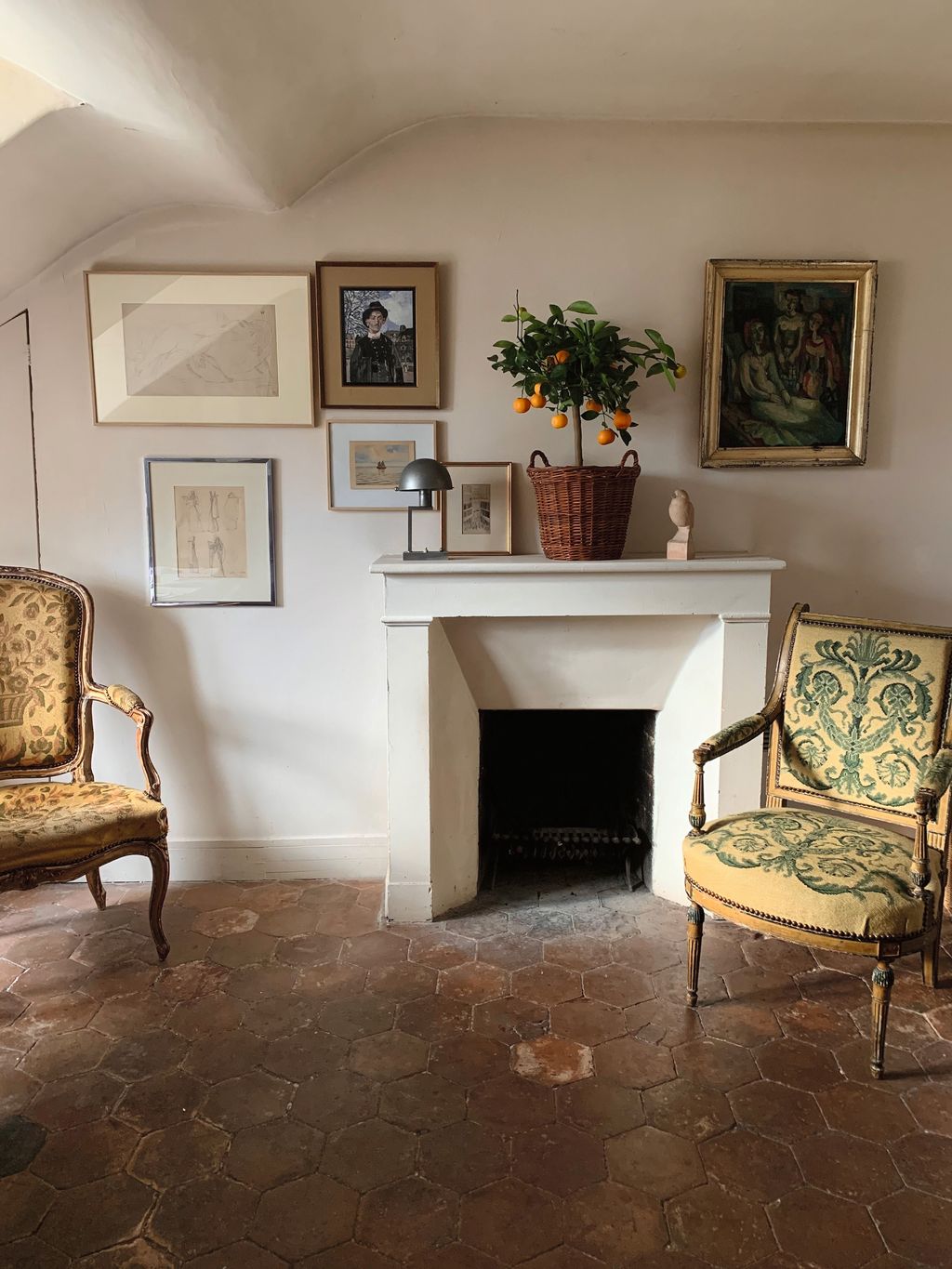 Image may contain Floor Chair Furniture Flooring Art Painting Plant Person Home Decor Lamp Fireplace and Indoors