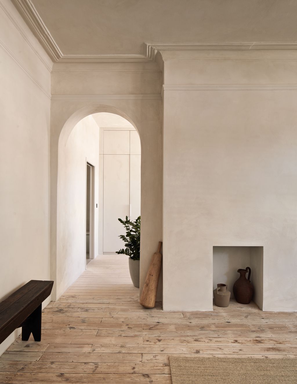 Image may contain Floor Flooring Indoors Interior Design Arch Architecture Bench Furniture Plant and Fireplace