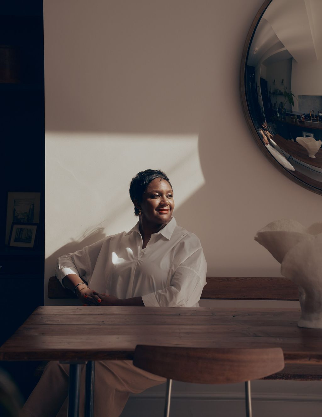 Image may contain Person Sitting Face Happy Head Smile Furniture Table Adult Photography Portrait and Art