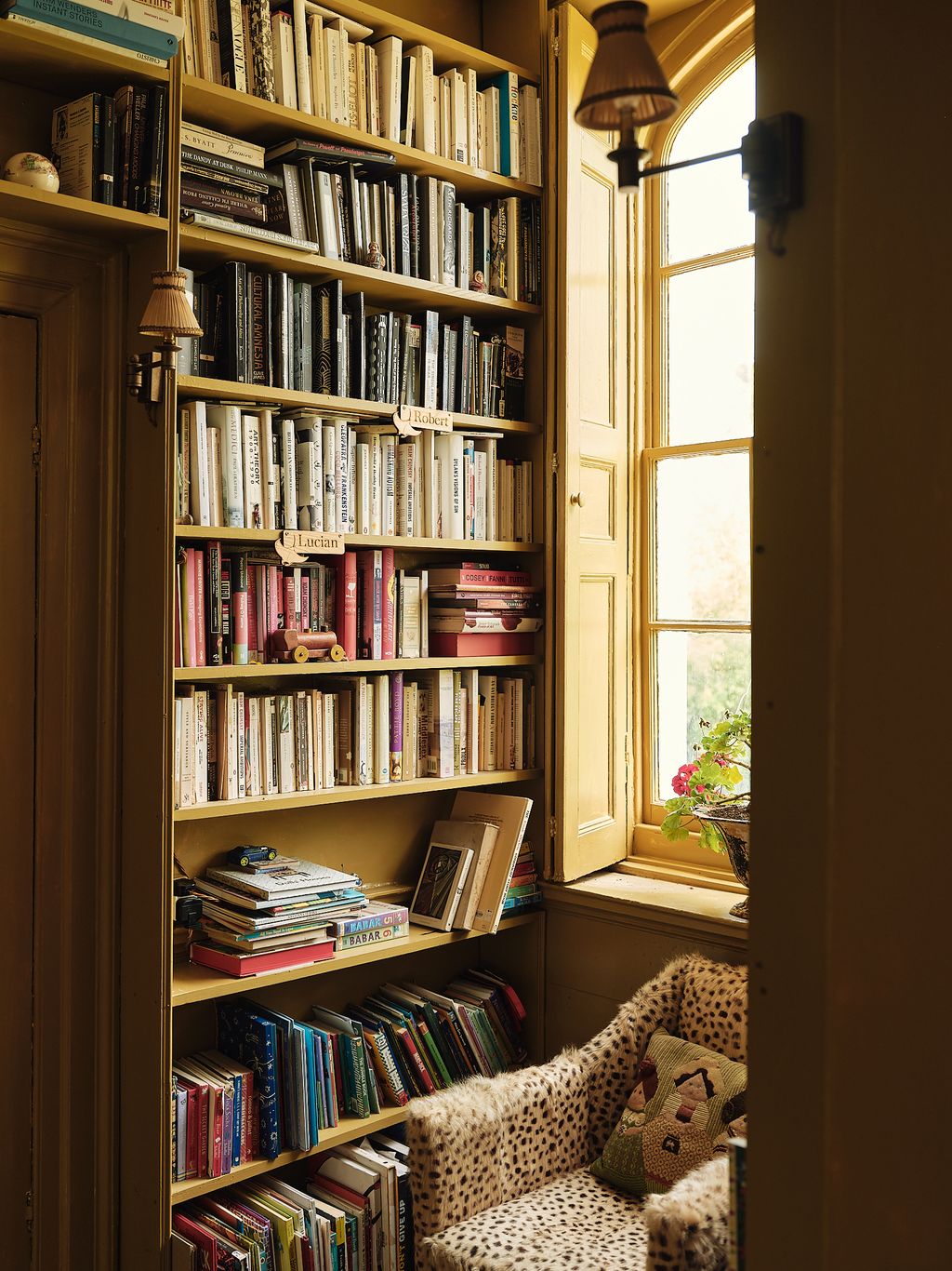 Image may contain Furniture Bookcase Lamp and Chair