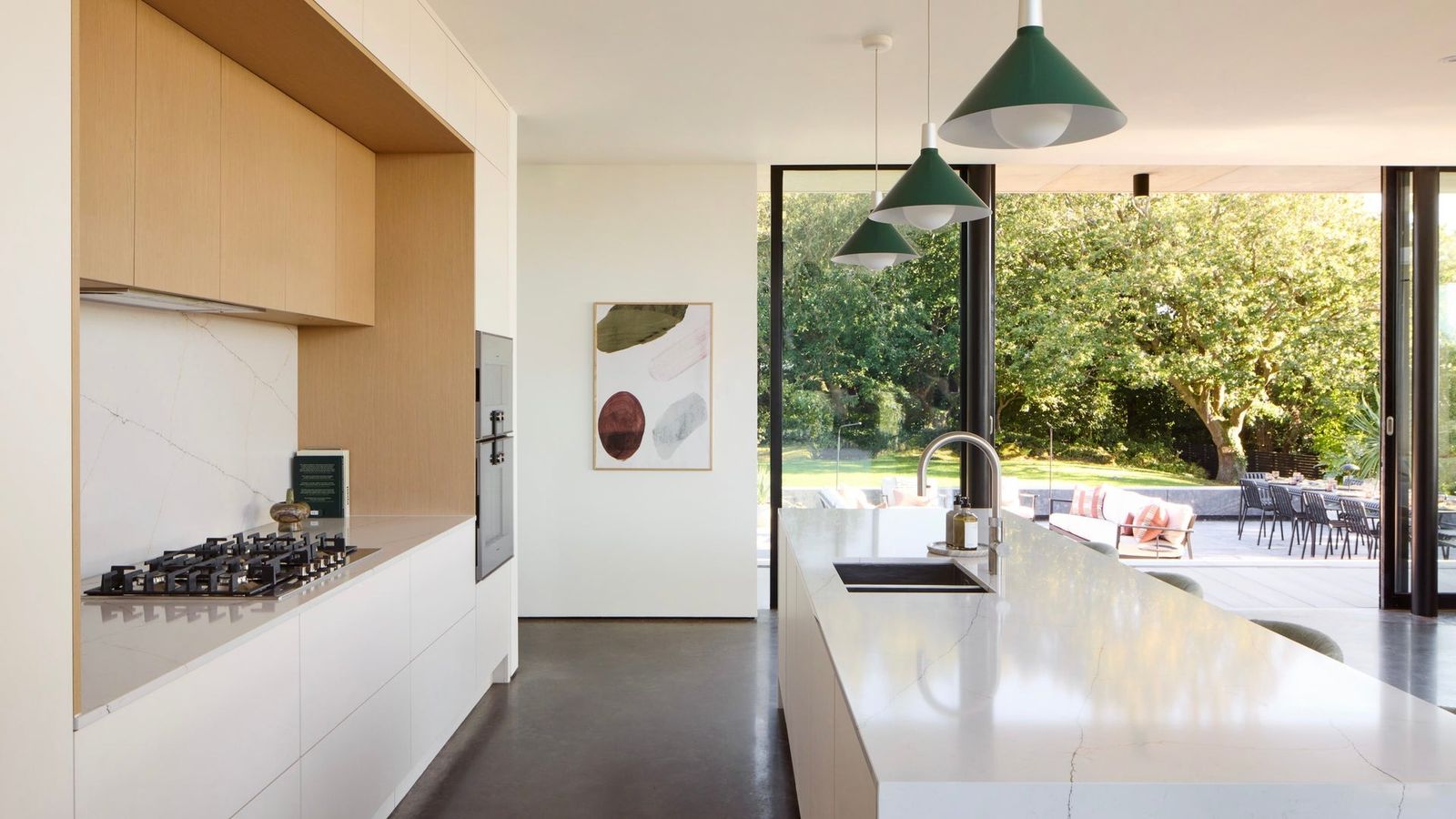 Image may contain Indoors Interior Design Kitchen Lamp Sink Cooktop Sink Faucet Art and Painting