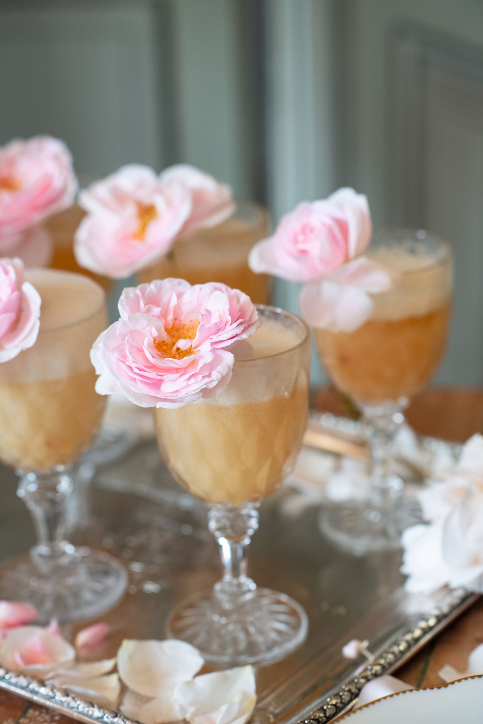 Image may contain Cream Dessert Food Icing Glass Flower Plant Rose Petal Mousse Goblet Furniture and Table