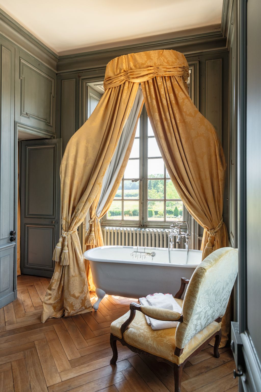 Image may contain Bathing Bathtub Person Tub Chair Furniture Sink Sink Faucet Indoors Interior Design and Window