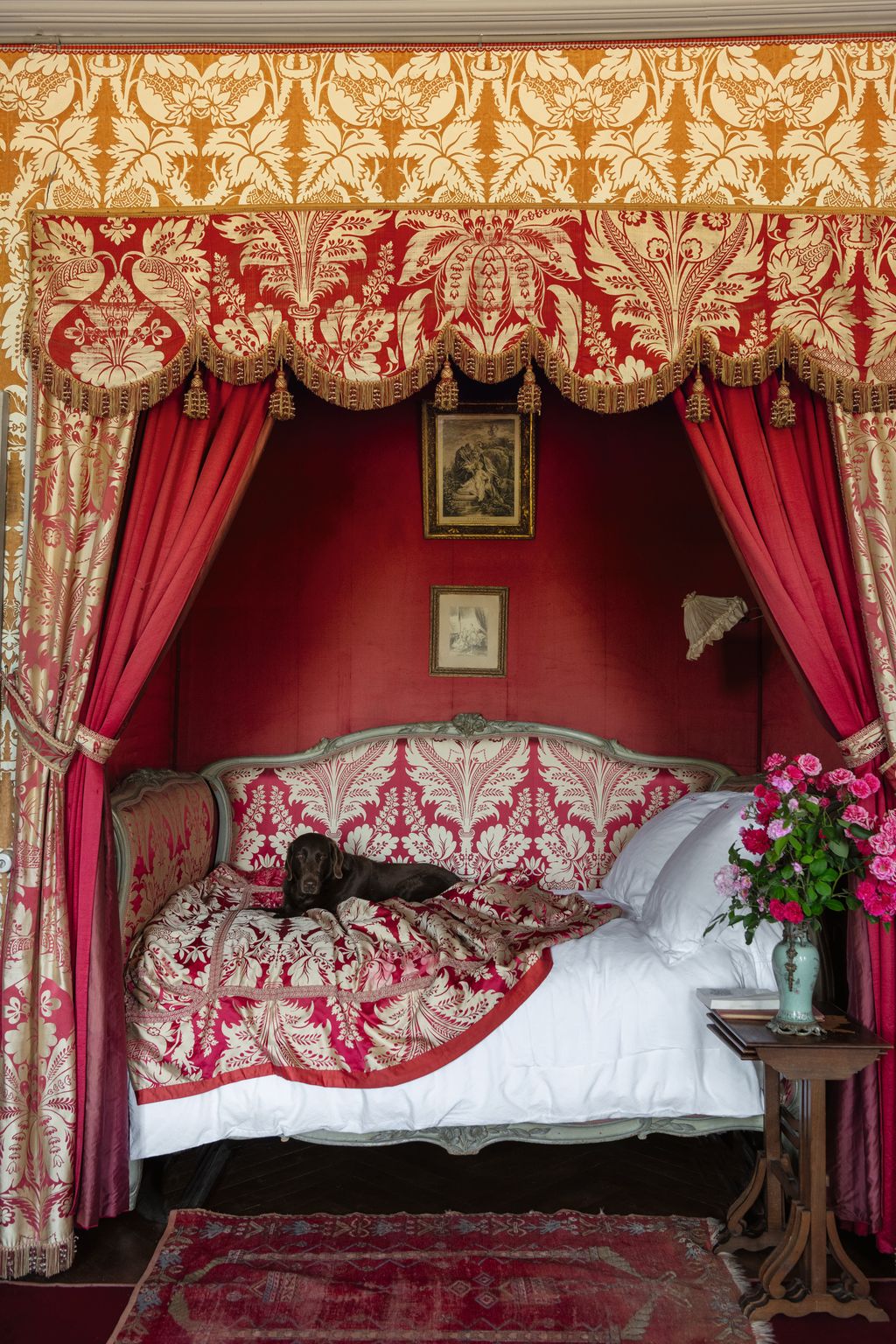 Image may contain Furniture Bed Bedroom Indoors Room Home Decor Rug Art Painting Animal Canine Dog and Mammal