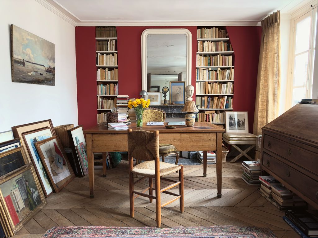 Image may contain Desk Furniture Table Indoors Interior Design Chair Art Painting Home Decor Rug Person and Wood