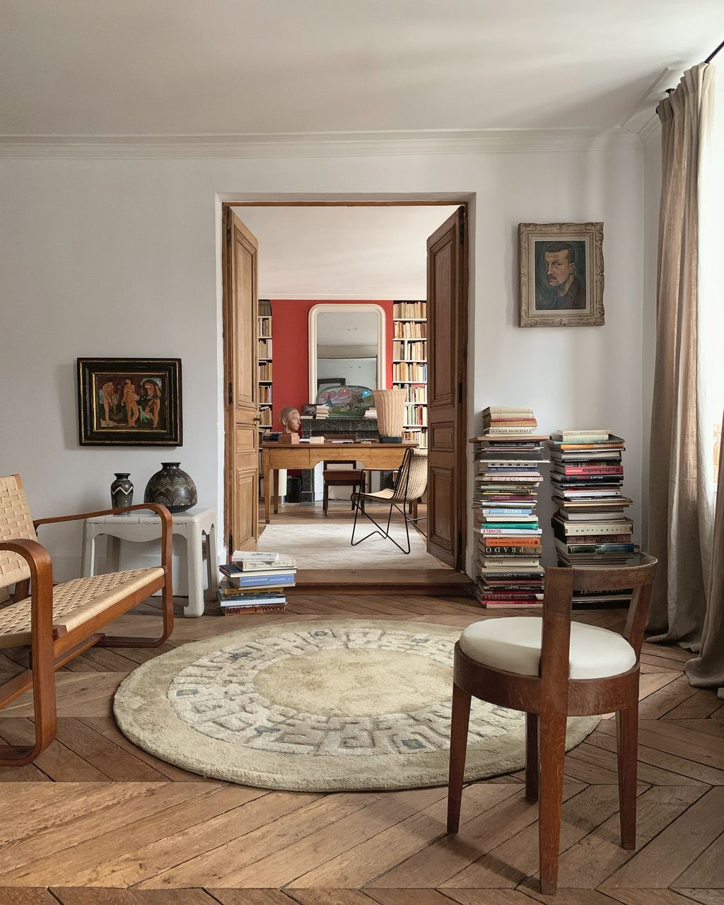 Image may contain Home Decor Desk Furniture Table Chair Rug Art Painting Indoors Interior Design Person and Floor