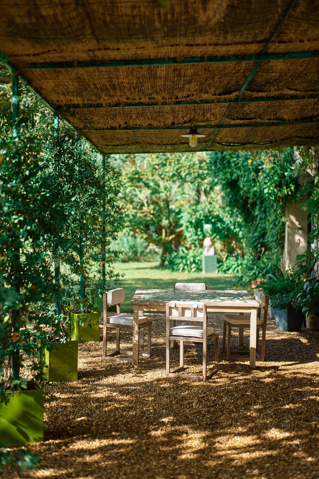 Image may contain Desk Furniture Table Architecture Building House Housing Porch Grass Plant Chair and Indoors