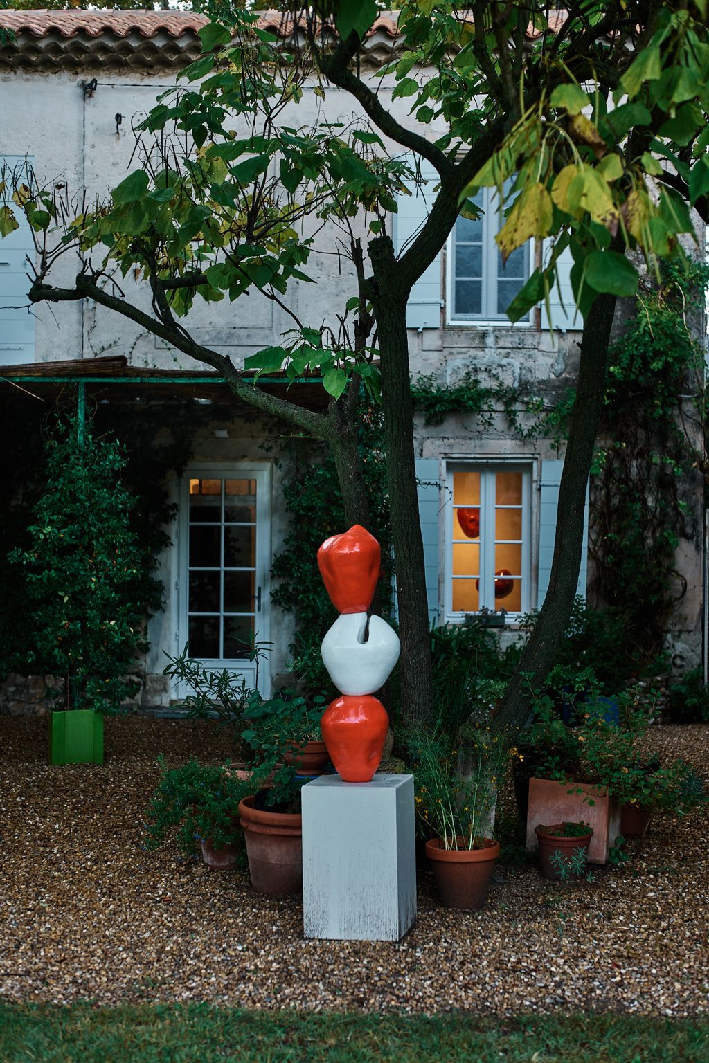 Image may contain Plant Potted Plant Jar Planter Pottery Vase Architecture Building House Housing Villa and Tree