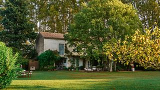 Image may contain Grass Plant Lawn Architecture Building Cottage House Housing Villa Chair Furniture and Nature