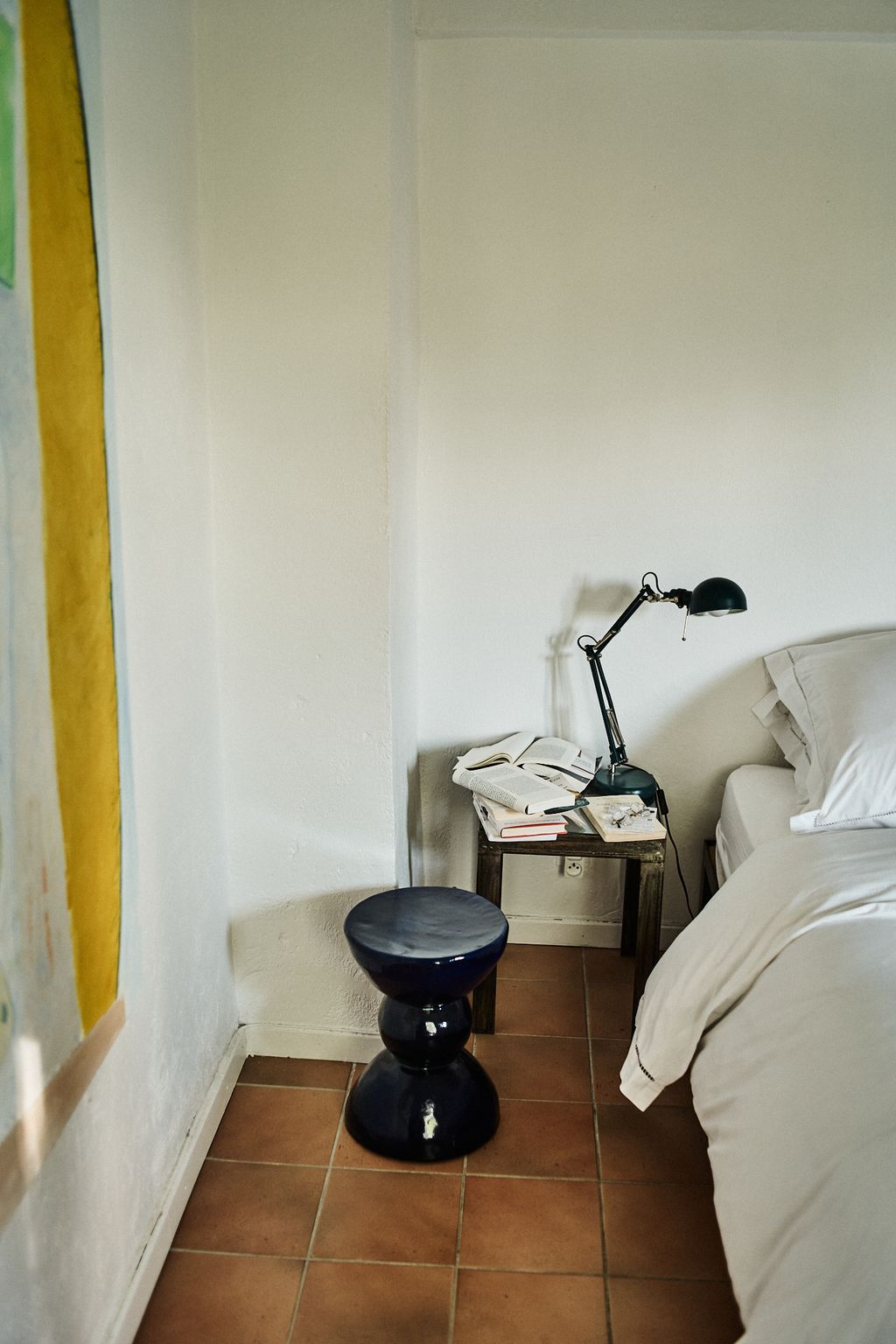 Image may contain Lamp Cushion Home Decor Book Publication Bed Furniture Floor Flooring Bedroom and Dorm Room