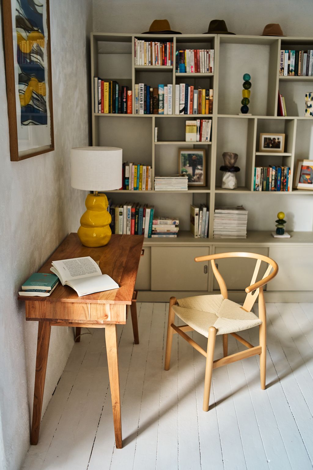 Image may contain Book Publication Lamp Furniture Chair Desk Table Clothing Hat Bookcase Art and Painting