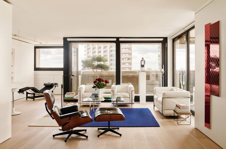 Image may contain: Home Decor, Chair, Furniture, Architecture, Building, Indoors, Living Room, Room, Person, Couch, and Table