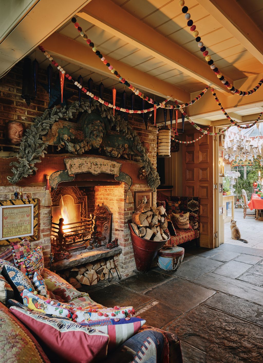 Image may contain Fireplace Indoors Chair Furniture Hearth Couch Person Animal Cat Mammal Pet and Home Decor