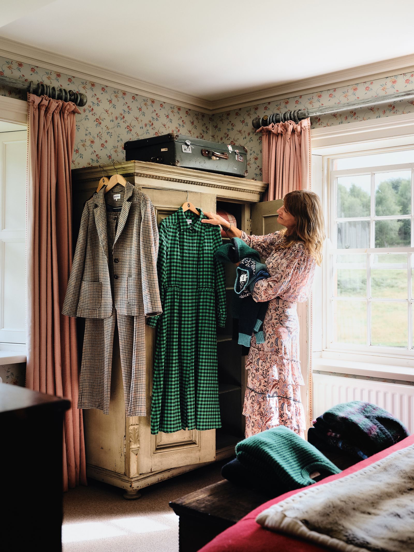 Image may contain Dressing Room Indoors Room Adult Person Furniture Clothing Glove Box Bed Bedroom and Closet