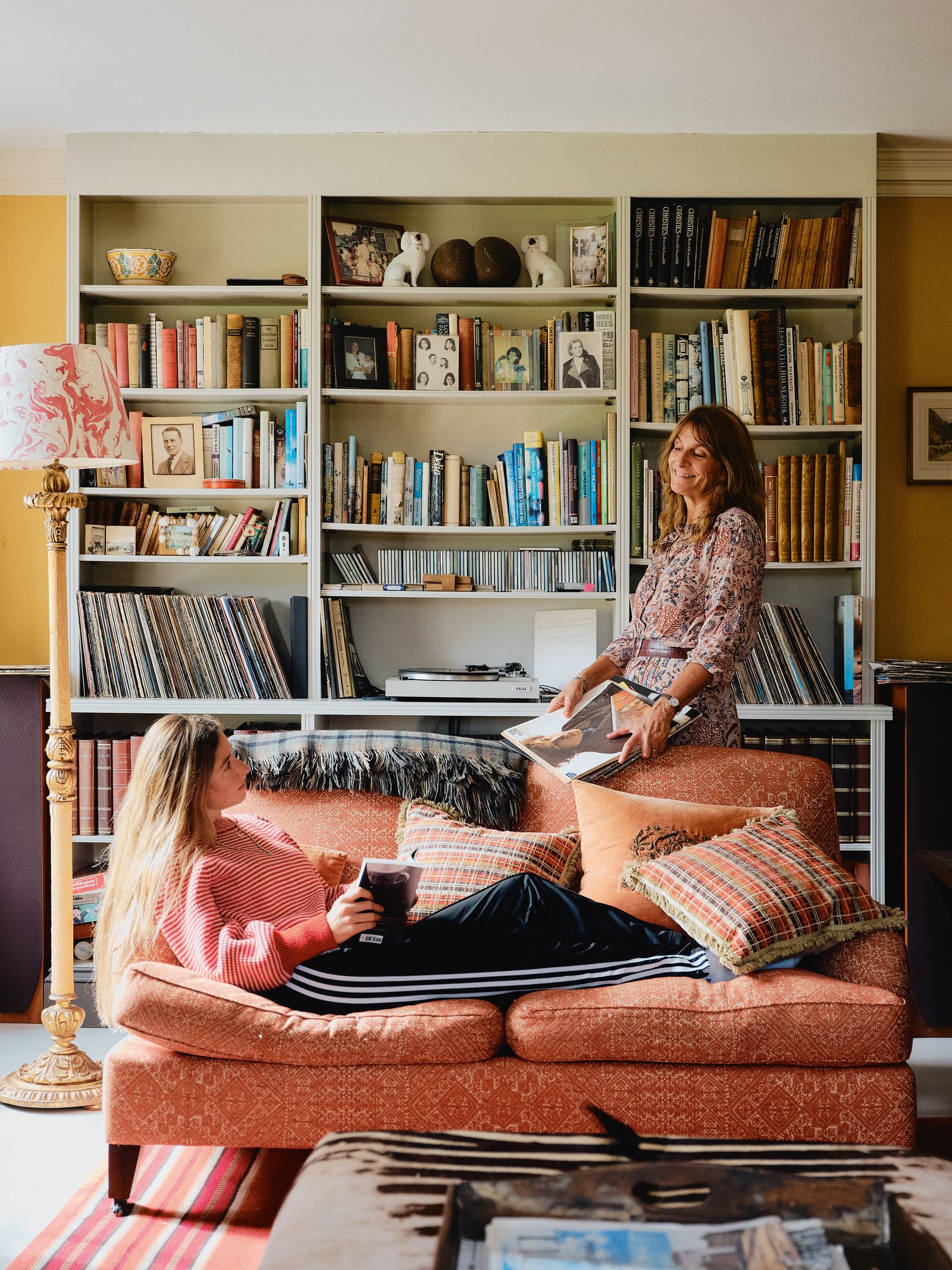 Image may contain Eva Polttila Book Publication Furniture Couch Lamp Art Painting Adult Person Bookcase and Toy