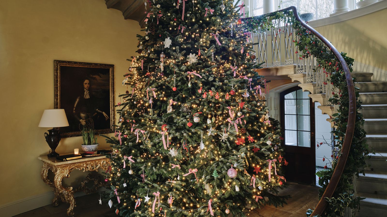 Image may contain: Lamp, Architecture, Building, House, Housing, Staircase, Art, Painting, Desk, Furniture, Table, and Person