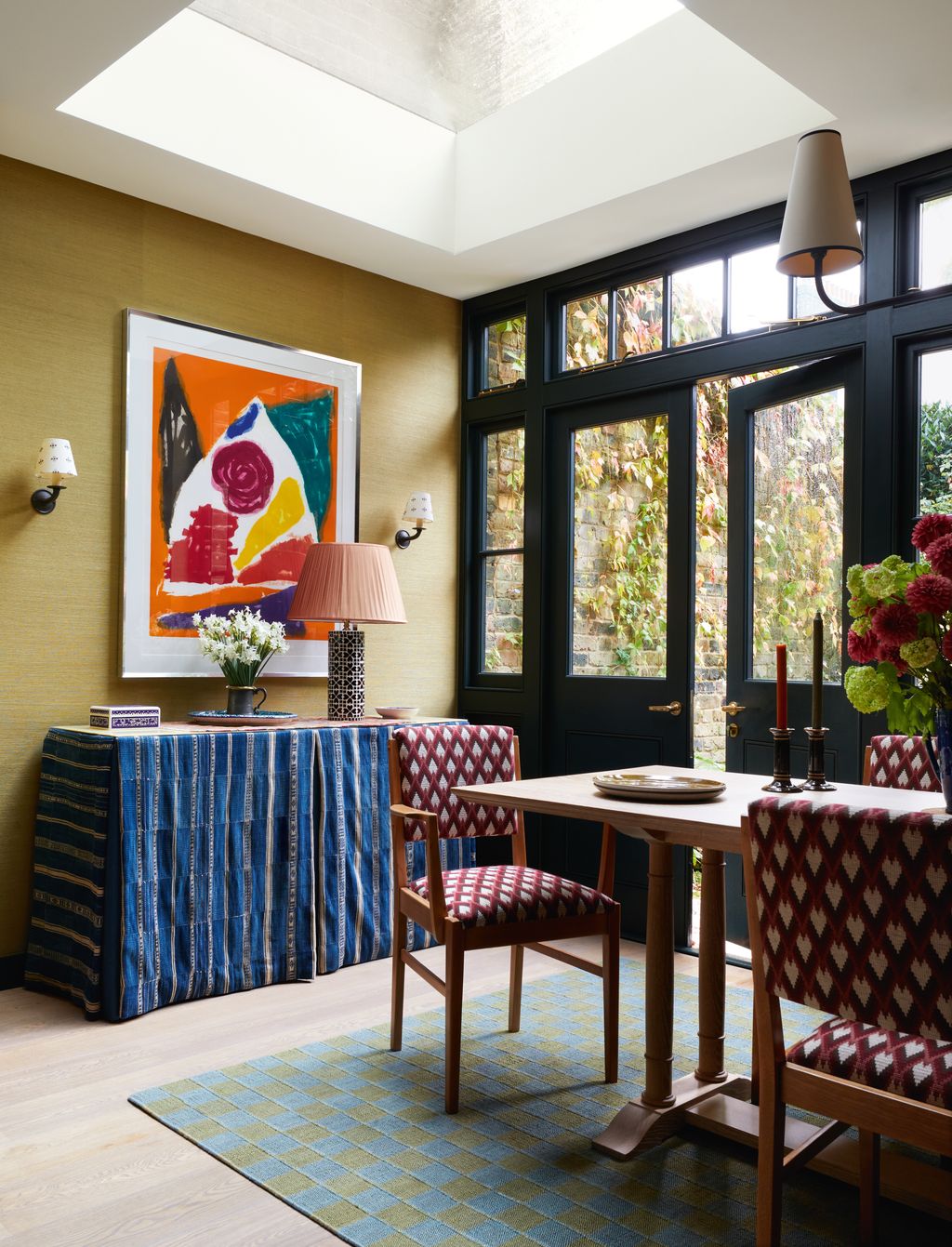 Image may contain Lamp Chair Furniture Home Decor Indoors Interior Design Art Painting Desk Table Candle and Rug