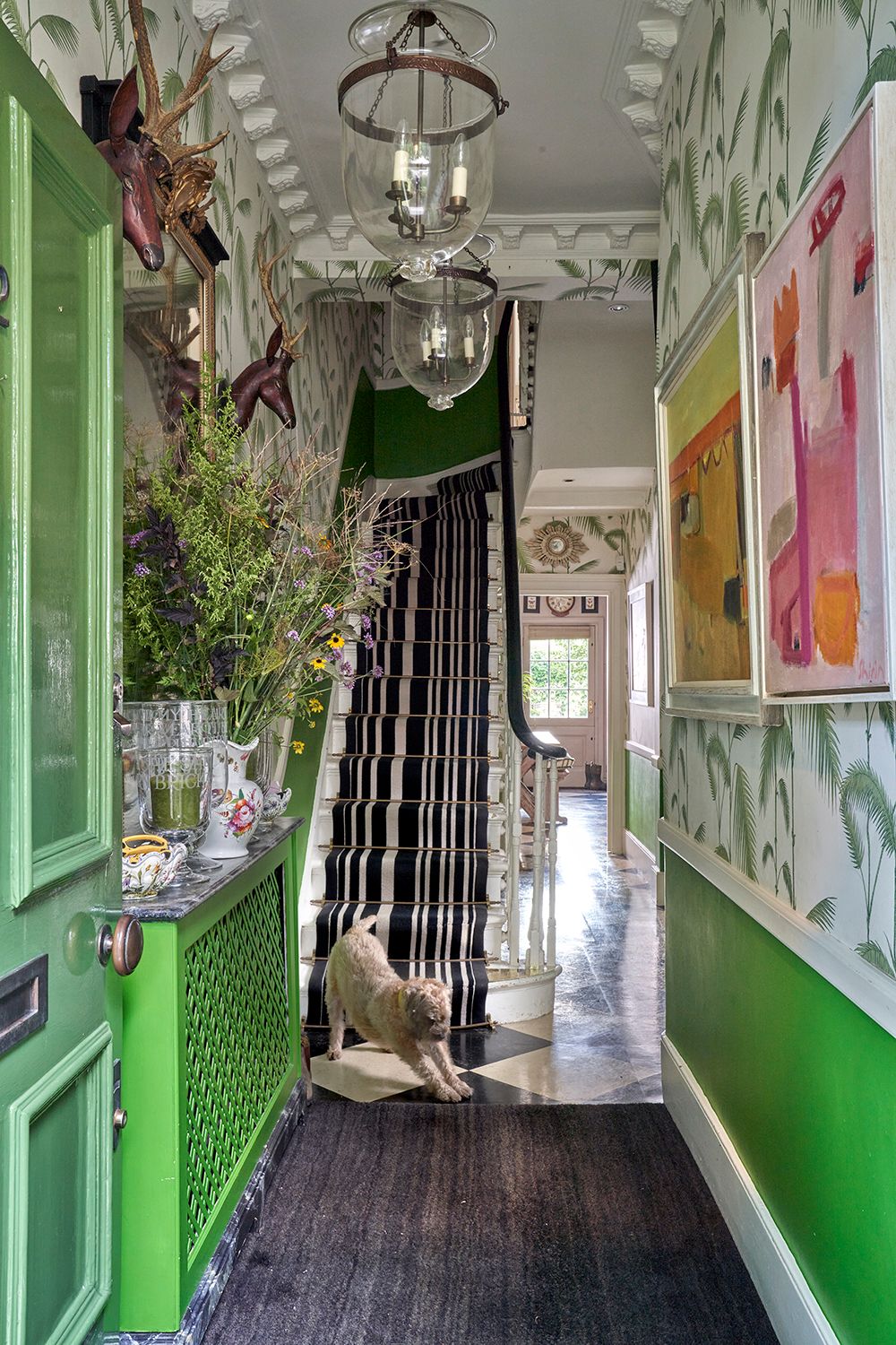 Image may contain Indoors Interior Design Floor Lamp Chandelier Animal Canine Dog Mammal Pet and Person