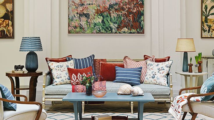 Image may contain: Home Decor, Coffee Table, Furniture, Table, Lamp, Cushion, Couch, Chair, Desk, Art, Painting, and Plant