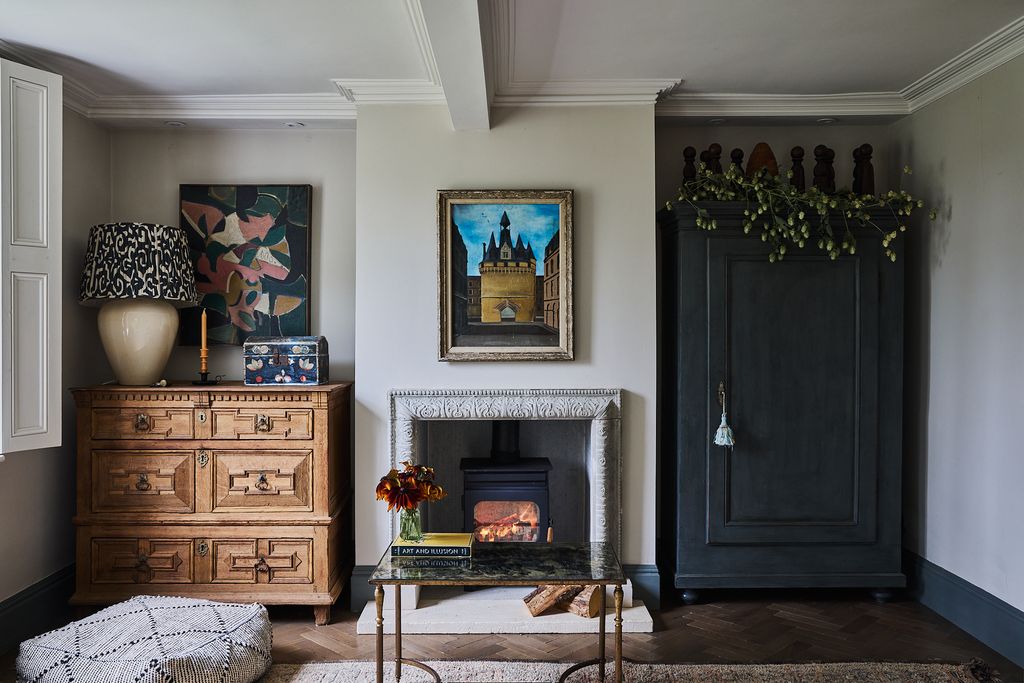 Image may contain Lamp Indoors Interior Design Fireplace Home Decor Art Painting Box Desk Furniture and Table