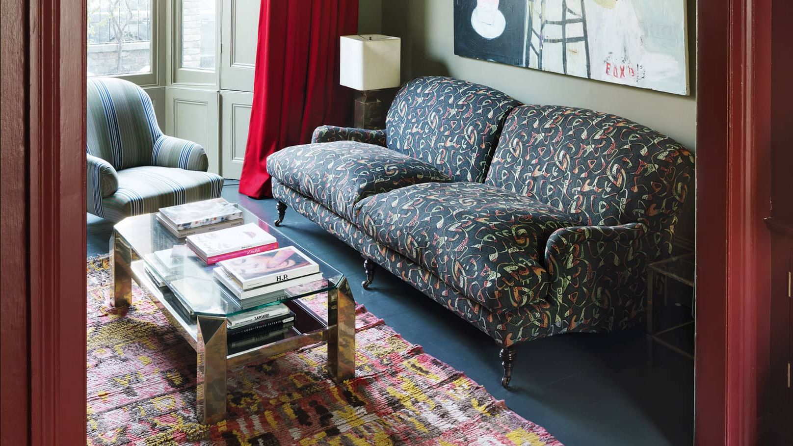 Image may contain: Couch, Furniture, Lamp, Architecture, Building, Indoors, Living Room, Room, Home Decor, Rug, and Table