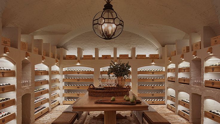 Image may contain: Lamp, Alcohol, Beverage, Liquor, Wine, Desk, Furniture, Table, Bench, Wine Cellar, Cooktop, and Indoors